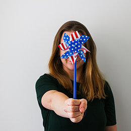 Young woman holds a pinwheel in the American colors ©Amerikahaus München